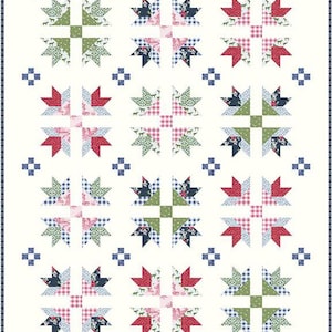 May include: A white quilt with a repeating pattern of star-like shapes. The stars are composed of various fabrics in red, green, blue, and pink, with gingham and floral prints. Small blue square accents are scattered throughout.