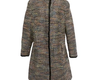 May include: A long, multi-colored tweed coat with a black zipper and trim. The coat has a high collar and long sleeves. The tweed pattern includes black, white, blue, and yellow threads.