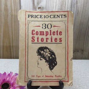 May include: Vintage paperback book cover with the title "30 Complete Stories" and a price of 10 cents. The cover features a black and white illustration of a woman with dark hair.