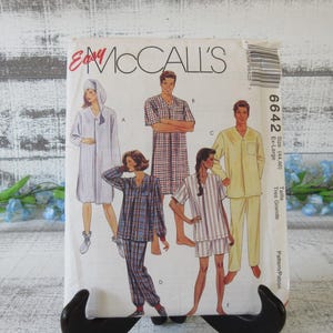 May include: Vintage McCall's sewing pattern for sleepwear. The pattern features illustrations of various pajama styles, including a robe, long-sleeved pajamas, and shorts sets. The pattern size is Ex-Large.