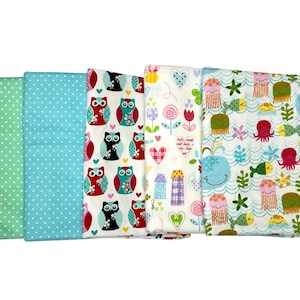 May include: Four fabric squares with different patterns. One square has a green background with white polka dots. Another square has a light blue background with white polka dots. A third square has a white background with colorful owls. The last square has a white background with colorful sea creatures and the text "Baby comes with baby, dry them up".