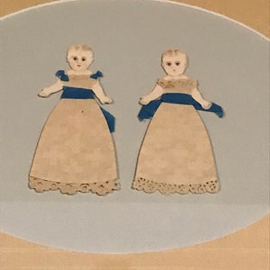 Framed antique paper twin babies.