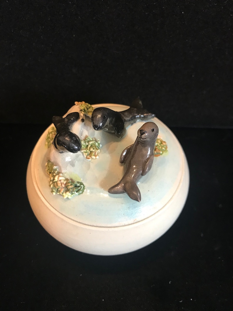 adorable 3-D seals on top. Pottery trinket jar with lid