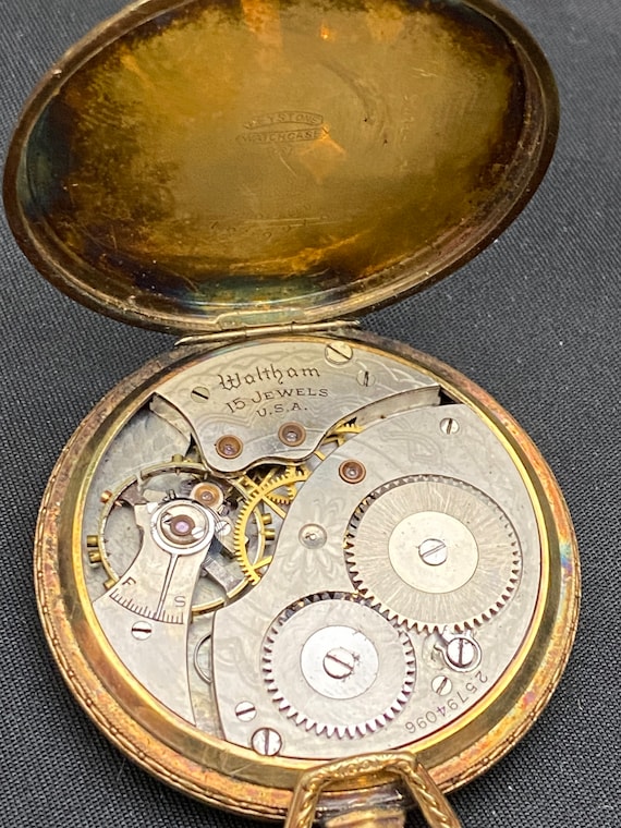 Antique brass pocket watch display with Eagle and a 1… Gem