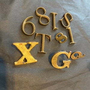 Antique wood and brass numbers and letters.