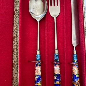 Vintage cloisonné handled cutlery, set silver, toned knife, fork, and spoon in original box.
