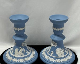 Pair of Wedgwood Jasperware candle holders with classical relief scenes on blue stoneware body.