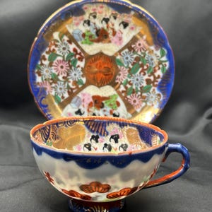 Antique Japanese Kutani porcelain tea cup and saucer .