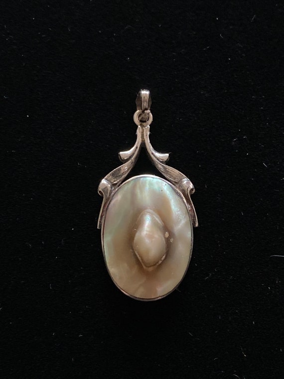 Antique blister pearl pendant set in silver.