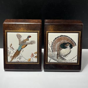 May include: A set of three ceramic vases in varying heights. The vases are white with a textured, ridged design. The tallest vase is approximately 10 inches tall, the medium vase is 8 inches, and the smallest is 6 inches.