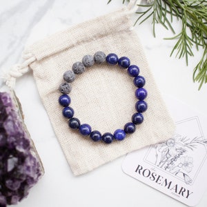 May include: A blue and gray beaded bracelet with a small pouch and a card that says "The Rosemary Collection".