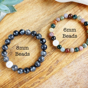 May include: Two bracelets made with gemstone beads. The bracelet on the left has 8mm black beads and the bracelet on the right has 6mm multi-colored beads.