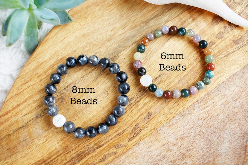 May include: Two bracelets made with gemstone beads. The bracelet on the left has 8mm black beads and the bracelet on the right has 6mm multi-colored beads.