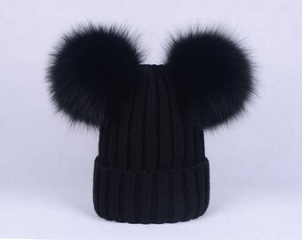baby hat with two pom poms