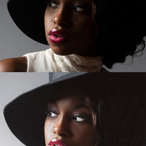 May include: A woman wearing a black wide-brimmed hat and a white top with a lace collar. She has dark skin, red lipstick, and a gold necklace. The image is a close-up portrait with a gray background.