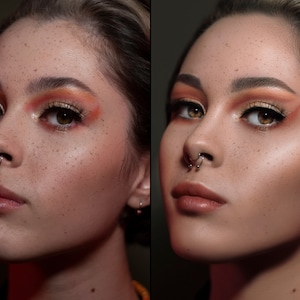 May include: A portrait of a person with freckled skin, wearing eye makeup with orange and gold tones. They have a septum piercing and a neutral lip color. The image is well-lit, highlighting the details of the makeup.