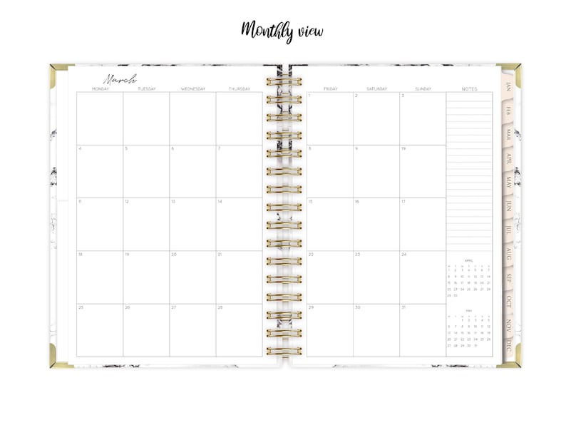 May include: A monthly planner with a marble cover and gold accents. The planner has a spiral binding and includes a calendar view for March. The planner also includes a notes section and a smaller calendar view for the year.