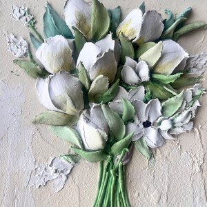 May include: A white and green 3D floral painting with a textured surface. The painting features a bouquet of white flowers with green leaves and stems.