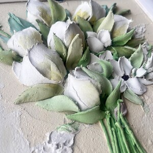 May include: A close-up of a white and green 3D floral painting. The flowers are arranged in a bouquet and have a textured, realistic look.