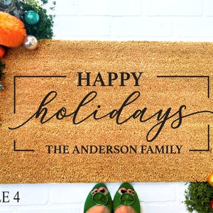 May include: A brown coir doormat with the text "HAPPY holidays THE ANDERSON FAMILY" in a black frame.