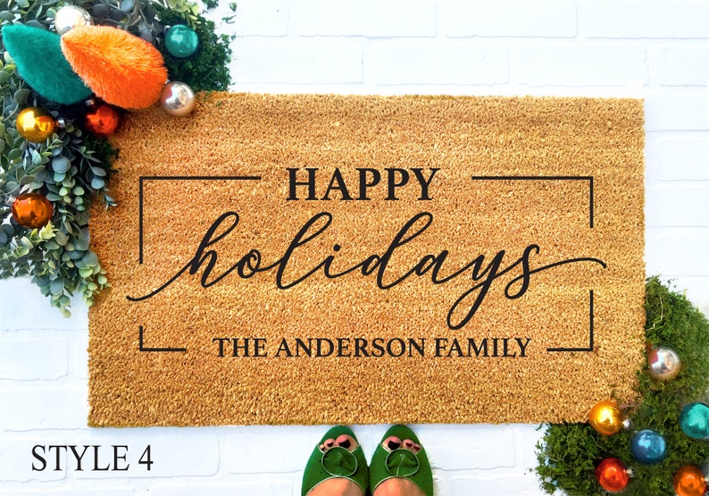 May include: A brown coir doormat with the text "HAPPY holidays THE ANDERSON FAMILY" in a black frame.