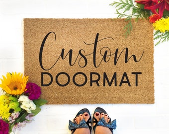 May include: A brown coir doormat with the text "Custom Doormat" in black lettering.