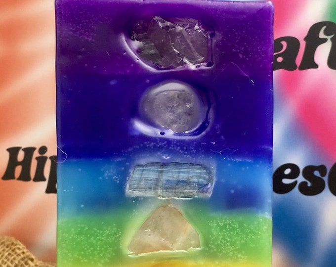 Tall Square 7 Layer Candle inlaid with Crystals & Gemstones that represent each Chakra and illuminate when lit! Burns for 200 hours