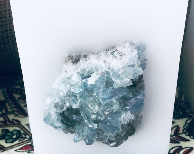 Crystal Candle~ White Chub Square Candle with an inlaid Blue Celestine Crystal Cluster that illuminates when lit! Burns for 200 hours