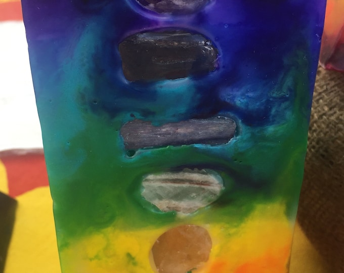 Tall Square 7 Layer Tie Dye Candle inlaid with Crystals & Gemstones that represent each Chakra and illuminate when lit! Burns for 200 Hours