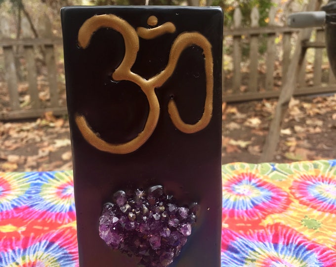Crystal Candle~ Tall Square Pillar Candle with an Om Symbol in Gold and an inlaid Amethyst Crystal Cluster that illuminates when lit!