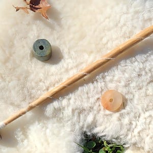 May include: A white ceramic mug with a black handle and the text "But First, Coffee" in a handwritten style. The mug is on a white surface. The mug is approximately 4 inches tall.