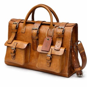May include: A tan leather briefcase with multiple pockets and straps. The bag has a top handle, a shoulder strap, and several buckles. A small tag with the word "RUSSARI" is attached to the front.