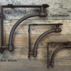 May include: Three rustic iron shelf brackets in different sizes: 5.5 inches, 7 inches, and 9.5 inches. The brackets are a dark brown color and have a curved design. The text "TuscanIron" and "Rustic Iron Brown" is visible in the image.