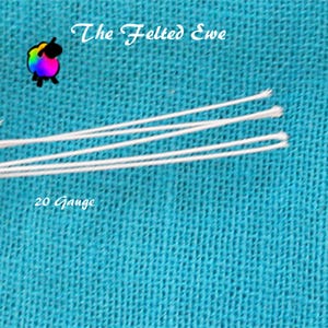 May include: Close-up of white threads against a textured turquoise background. The text "The Felted Ewe" is at the top, with a colorful sheep logo. The text "20 Gauge" is at the bottom, indicating the thread's thickness.