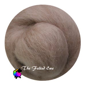 May include: A close-up of a light brown ball of wool fiber. The wool is soft and fluffy, and it is perfect for felting or spinning. The text "The Felted Ewe" is printed on the wool.