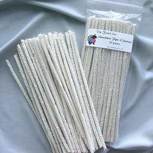 May include: A bag of white pipe cleaners for cleaning pipes. The bag is labeled "The Fiber Co. Artisan Pipe Cleaners 50 pack".