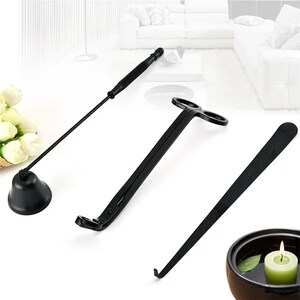 May include: A set of three black candle care tools. The tools include a candle snuffer, a wick trimmer, and a wick dipper. The tools are made of metal and have a black finish.