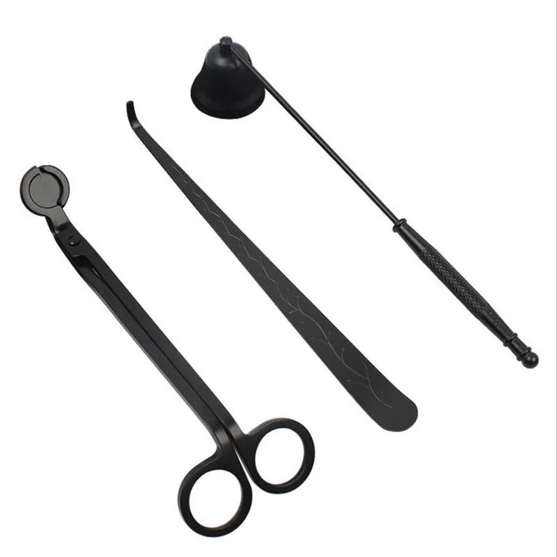 May include: A set of three black candle care tools: a snuffer, a wick trimmer, and a pair of wick scissors.
