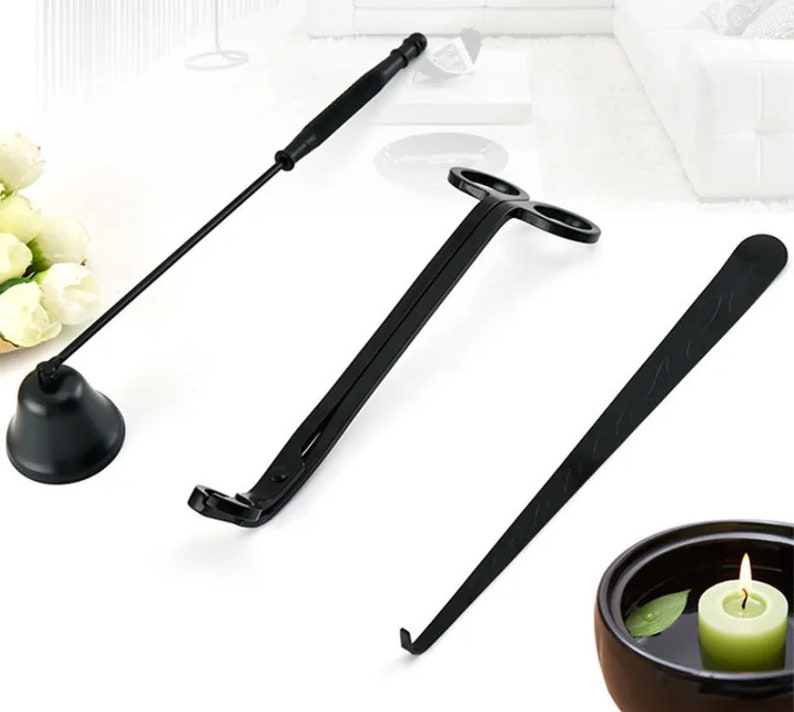 May include: A set of three black candle tools for trimming and extinguishing candles. The tools include a candle snuffer, a wick trimmer, and a wick dipper.