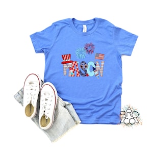 May include: A blue t-shirt with a red, white, and blue design featuring the name "MASON" in large letters. The letters are decorated with stars, stripes, and fireworks.