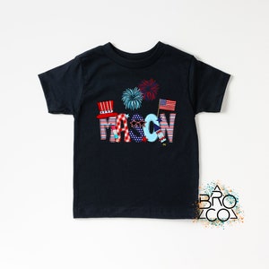 May include: A black t-shirt with a red, white, and blue design that says "MASON" with fireworks and American flags.