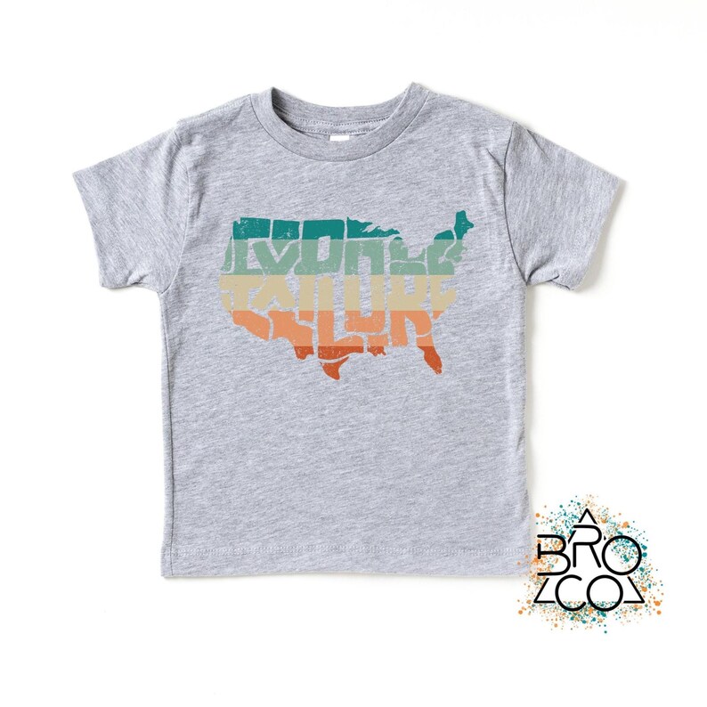 May include: A heather gray short-sleeve t-shirt featuring a graphic of the United States map filled with horizontal stripes in teal, yellow, and orange. The map design has a distressed, weathered texture across the front of the shirt.