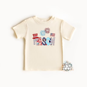 May include: A white t-shirt with a red, white, and blue design featuring the name "MASON" in large letters with stars, stripes, and fireworks.