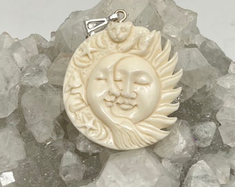 Carved Bovine Bone Sleeping Sun and Moon Pendant