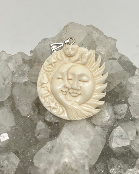 Carved Bovine Bone Sleeping Sun and Moon Pendant