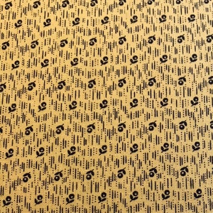May include: A yellow fabric with a repeating pattern of black stylized flowers and lines.