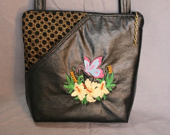 faux leather crossbody purse, black faux leather accented with black and gold quilted fabric and colorful embroidered flower and butterfly