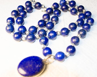 24.25 inch lapis lazuli necklace alternates lapis lazuli beads with silver beads and has a 39 mm sterling silver and lapis lazuli pendant