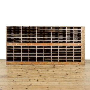 May include: A large wooden storage unit with multiple compartments. The unit is made of dark wood and has brass accents. It is a vintage style piece of furniture.