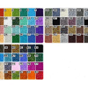May include: A collection of small, colourful seed beads organised in three rectangular plastic containers. Each compartment holds a distinct colour, ranging from vibrant reds, blues, and greens to metallic, black, and white tones, labelled with numbers 1 through 84.